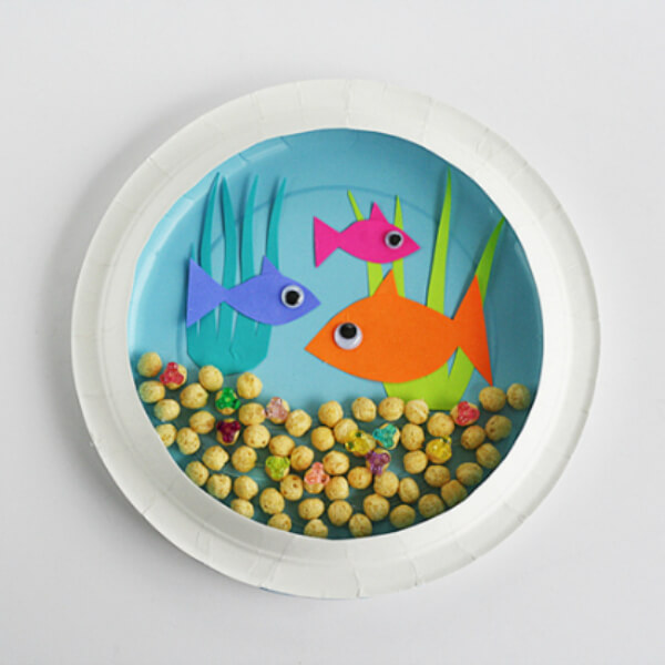 Easy Paper Plate Aquarium Craft With Colorful Paper Fish, Plants, Googly Eyes & Cereal - Creative projects for early childhood-age children using cereal. 