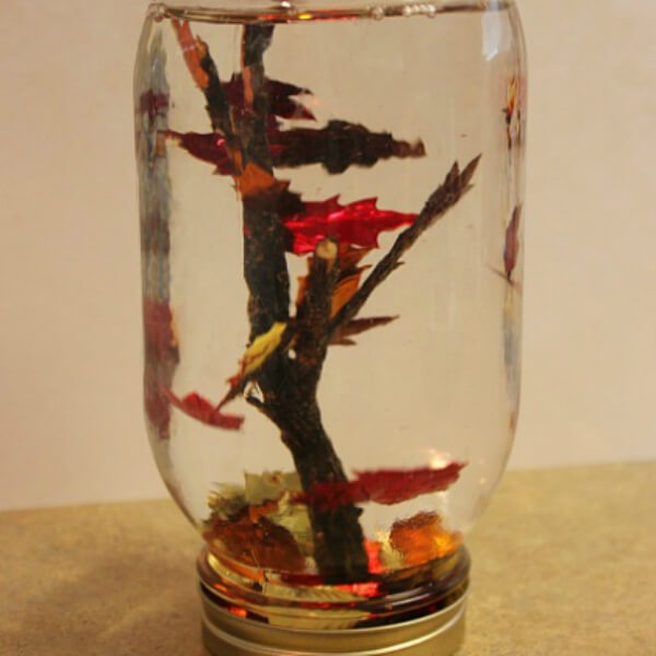 Adorable Fall Leaf Globe Craft Using Mason Jar & Small Tree Branch - Simple Leaf Projects For Five To Seven-Year-Olds