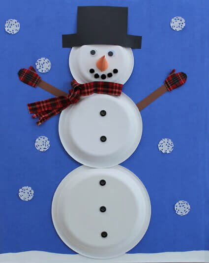Adorable Snowman Decoration Winter Craft With Paper Plates. Paper Cone, Buttons, & fabric Scarf - A fun winter craft for children - making a snowman out of a paper plate.