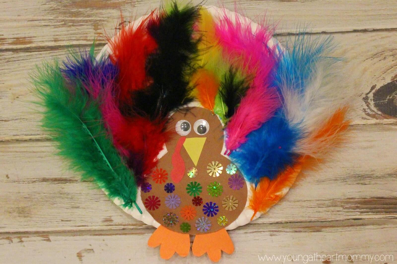 Beautiful Turkey Craft Made With Colorful Feathers, Paper Plate, Construction Paper, Googly Eyes & Embellishments - Feather Arts & Crafts For Children