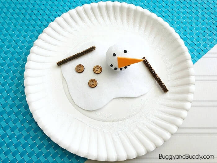 Cute Melting Snowman Paper Plate Craft Using White Felt, Small Styrofoam Ball, Buttons, Brown Pipe Cleaners & Black Puffy Paint - Making a snowman out of a paper plate - a great winter craft for children. 