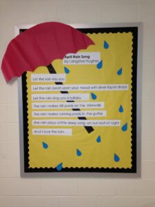 Displaying April Rain Song On Bulletin Board With Paper Umbrella & Some Rain Drop