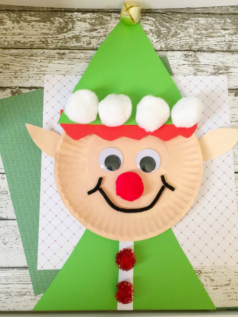 DIY Christmas Elf Paper Plate Craft Using Construction Paper, Pom Pom, Cotton Balls, Jingle Bell, Pipe Cleaners, & Googly Eyes - Simple Home-made Elf Arts and Crafts on Paper Plates