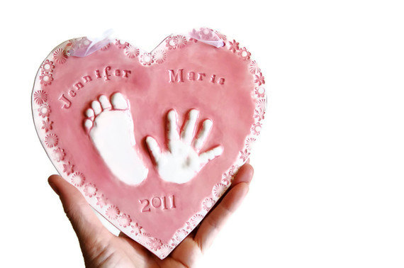 Easy Keepsake Baby Footprint Craft Idea In Heart Shaped Using Clay - Creating a clay footprint of a newborn to preserve a memory.