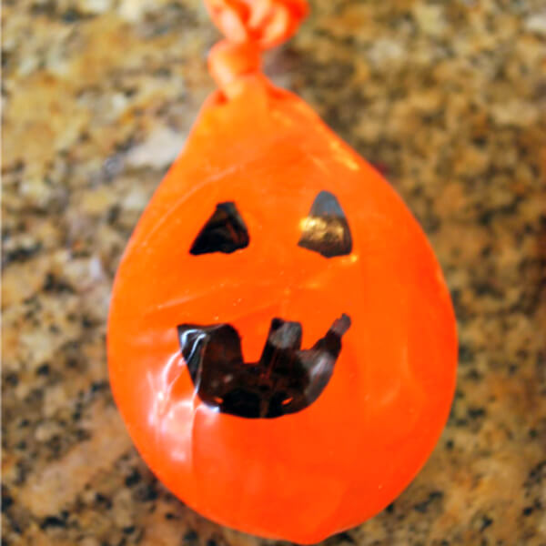 Halloween Game Ghost Toss Activity Made With Orange balloons, Flour, & Black Permanent Marker - Arts and Crafts for Preschoolers to Enjoy on Halloween