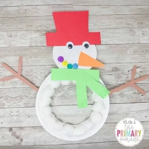 Handcrafted Snowman Craft Activity Using Cotton Balls, Paper Plates, Googly Eyes & Buttons - Winter crafting for kids - a snowman from a paper plate. 