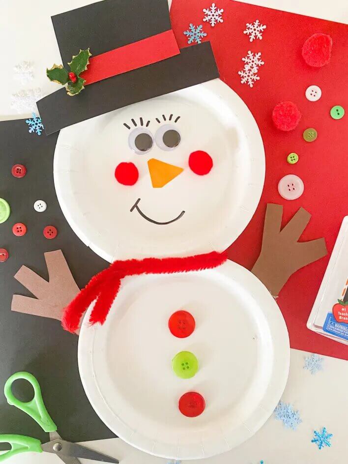 Handmade Snowman Winter Craft Made With Paper Plate, Buttons, Pom Pom, Googly Eyes, Pipe Cleaners & Colorful Papers - Construct a snowman from a paper plate - a terrific winter craft for youngsters. 