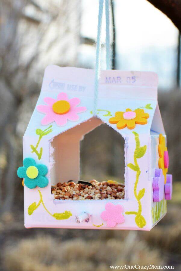 Homemade Milk Carton Bird Feeder Craft With Flower Stickers - Ideas for creating a bird feeder from a milk carton