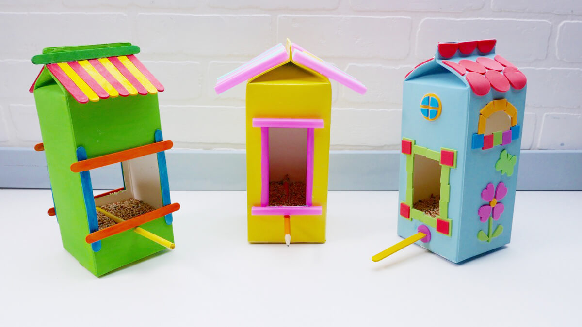 Make Your Own Recycled Bird Feeder Craft Using Milk Cartons & Popsicle Sticks - Ideas for using a milk carton as a bird feeder