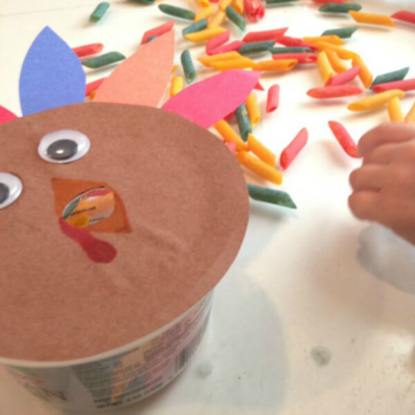 Recycled Thanksgiving Craft Activity Using Empty Plastic Container, Pasta, Turkey Face With Feathers & Googly Eyes - Creative Tasks For Kids on Thanksgiving