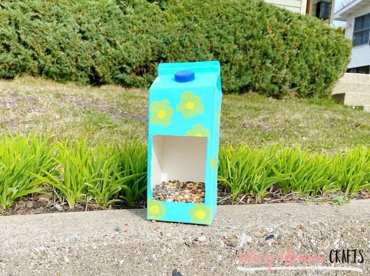 Simple Bird Feeder Craft Made With Empty Milk Cartons, Paints, & Flower Pattern - Creating Bird Feeders Using Milk Containers