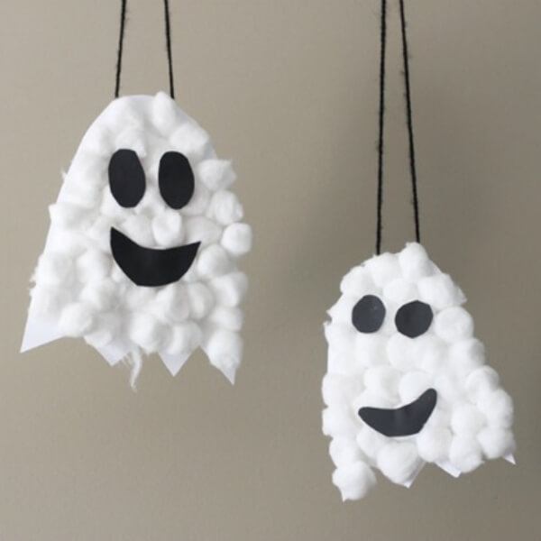 Simple Puffy Halloween Ghost Hanging Craft Idea Using Cotton Balls, Black Paper, & String - Creative and Fun Art Projects Using Cotton Balls 