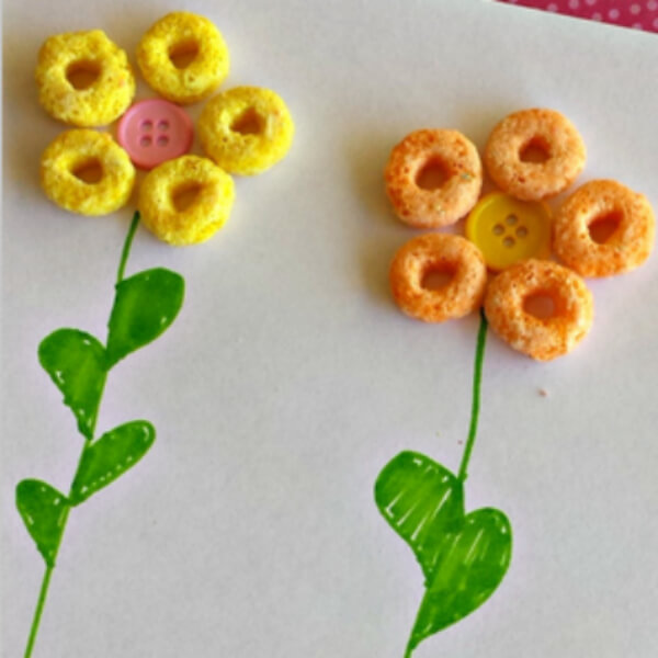 Very Simple Flower Craft Made With Yellow, Orange Cereal, Buttons & Green Marker - Creative Projects Utilizing Cereal For Pre-Kindergarteners