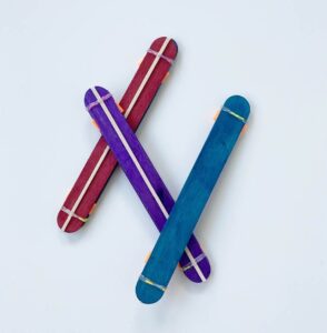 Adorable Kazoo Musical Instrument Craft Activity Made With Popsicle Sticks, Rubber Bands & Paint