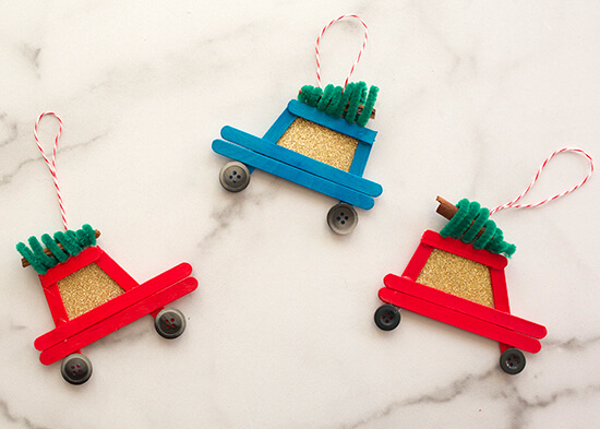 Handmade Toy Car Ornaments Crafts Made With Popsicle Sticks, Pipe Cleaners, Black Buttons, Cinnamon Sticks, Twine & Glitter Paper For Christmas