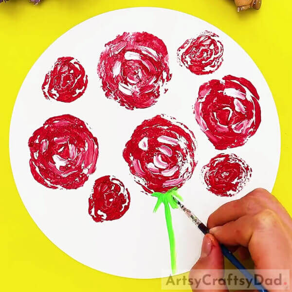 Drawing The Stem Of The Roses-Creating roses with cabbage stamps is a great idea for children. 