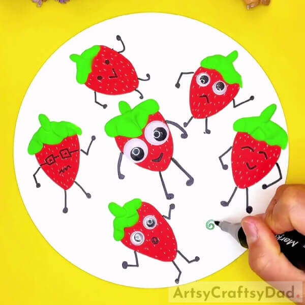Making The Features Of All The Strawberries And Spirals-Crafting paper and clay strawberries - a great way to keep kids entertained. 