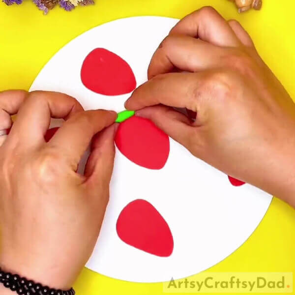 Sticking A Clay Roll-A fun project for children - paper and clay strawberries.