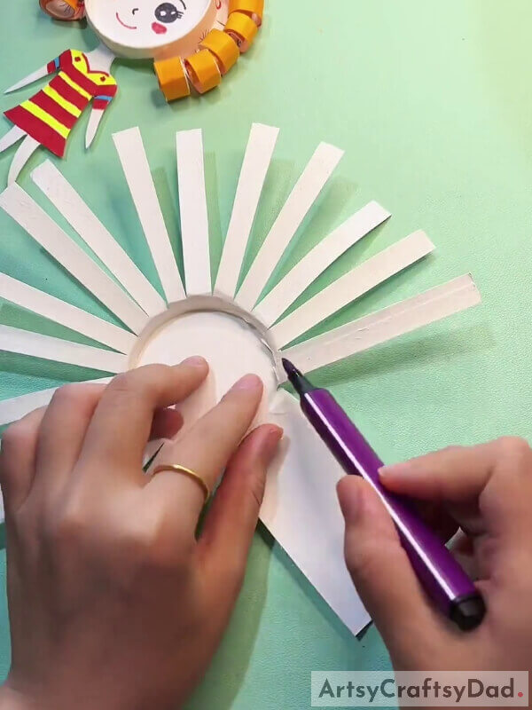 Bending The Thin Strips- Learn How To Make A Fun Paper Cup Craft With This Tutorial For Kids With Curly Hair