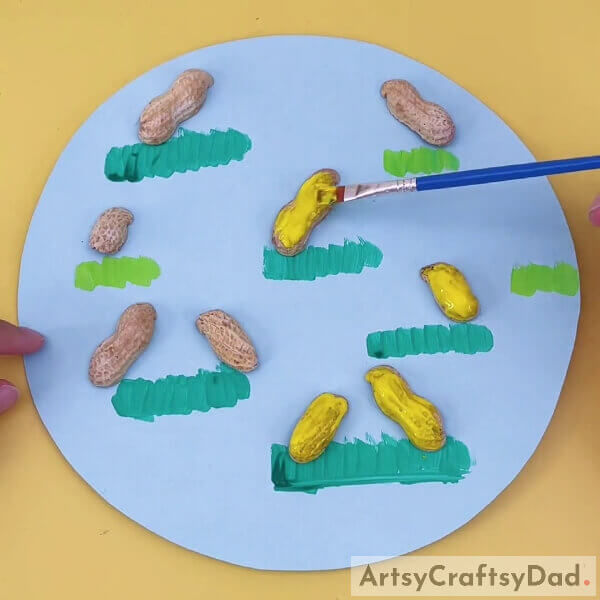 Coloring Peanut Shells Using Yellow Color Acrylic Paint- Peanut Shell Chick Artwork for Kids' Entertainment 