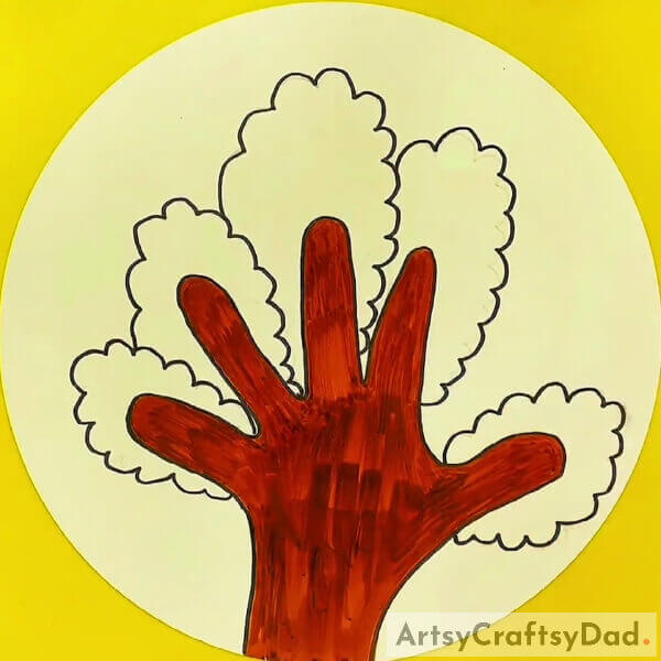Continue to finish coloring the hand - Taking Kids Through the Process of Crafting Trees with Hand Outlines 
