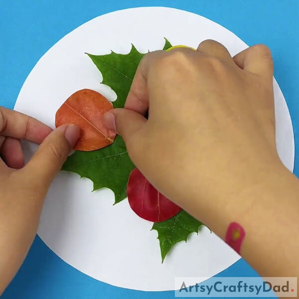 Cutting And Pasting Brown Color Leaf- Guide to Making Ladybugs on Leaves