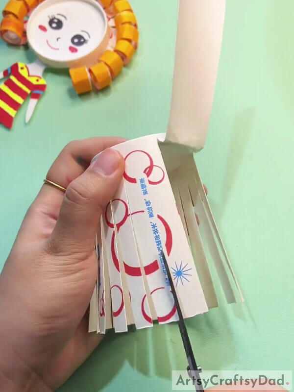 Cutting Thin Strips-Curly Haired Kids Can Create A Unique Paper Cup Craft Using This Guide