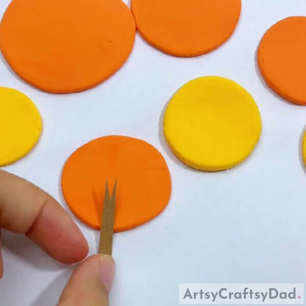 Cutting brown color construction paper for wood- Clay Autumn Wreath Trees How-to-Guide