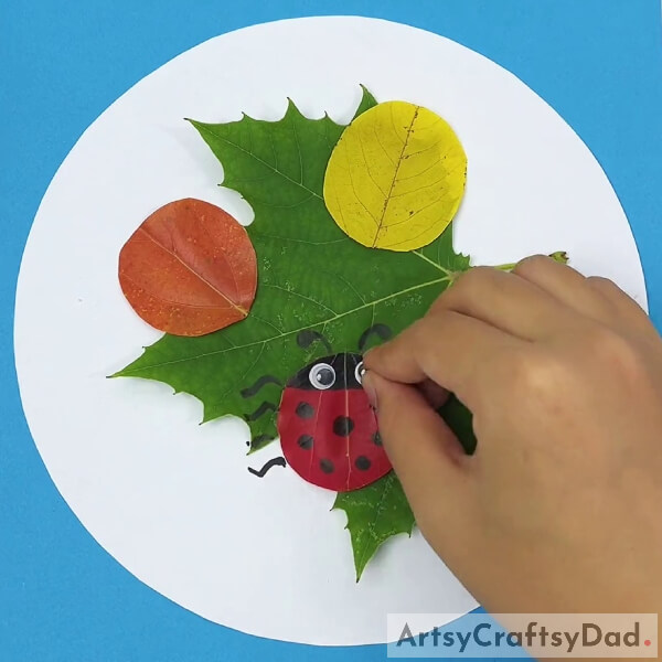Drawing Legs, Antenna And Pasting Googly Eye On Red Leaf- Crafting Leaves with Ladybugs Demonstration