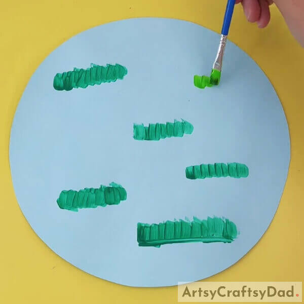 Drawing Light Green Color Grass On Construction Paper- Crafting Peanut Shell Chicks for Kids' Education