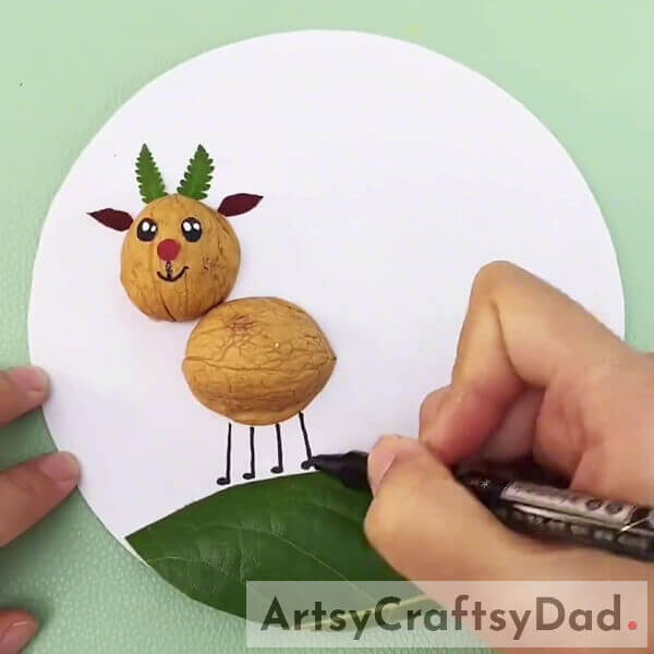 Drawing The Legs Of The Deer - Create a Deer Landscape with Walnut Shells and Leaves