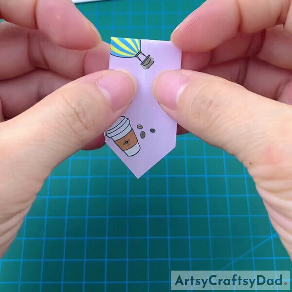 Folding The Figure In Half - This guide on how to make paper origami flip flops for children