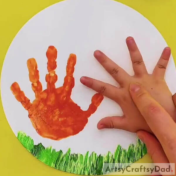Make an imprint of the palm of your hands with paint - A Guide to Making Art with Hands and Chickens
