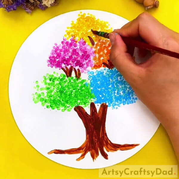 Making Branches Of The Tree- Youngsters can make artistic trees with earbud stamping. 