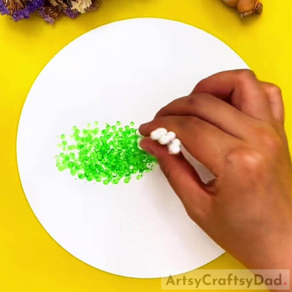 Making Green Leaves- Earbuds can be utilized to create tree art that is exciting for kids. 