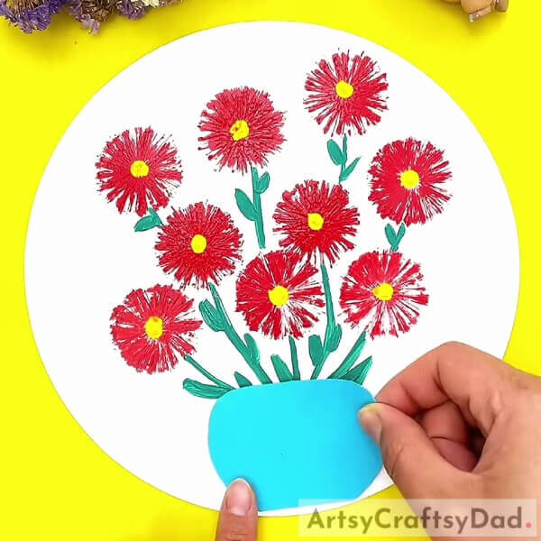 Making a pot for the flowers- Instructions for kids to create a stamp painting of red vector flowers. 