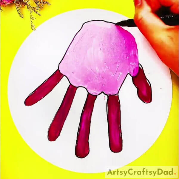 Now, Making an outline of the palm and fingers With a Marker - Crafting a Jellyfish Picture Using Handprints