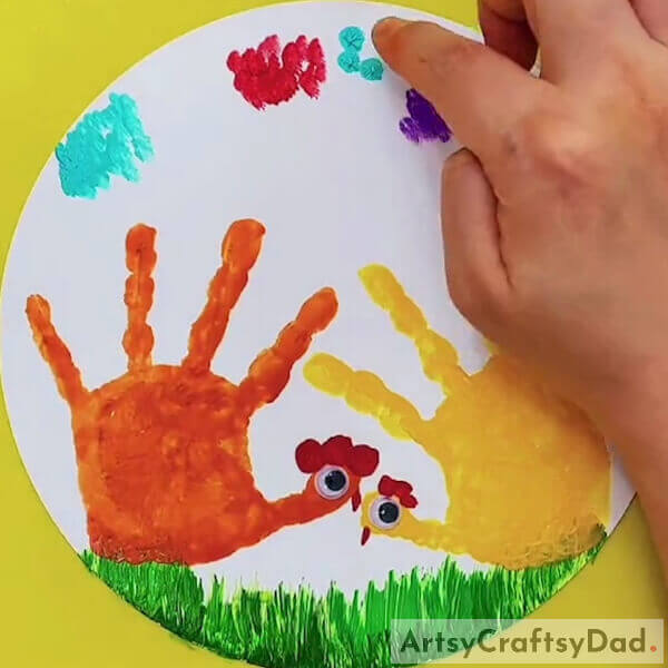 Now make fingertip impressions around the clouds - A Handprint Chicken Art Tutorial