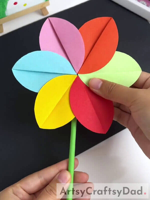 Pasting A Stick To The Flower - A paper pinwheel flower craft guide for kids 