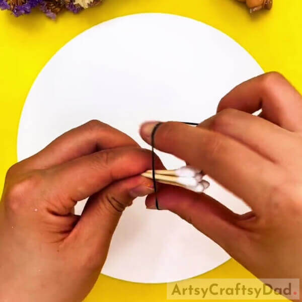 Securing A Bunch Of Cotton Earbuds Together- Kids can produce vibrant tree designs with earbud stamping. 