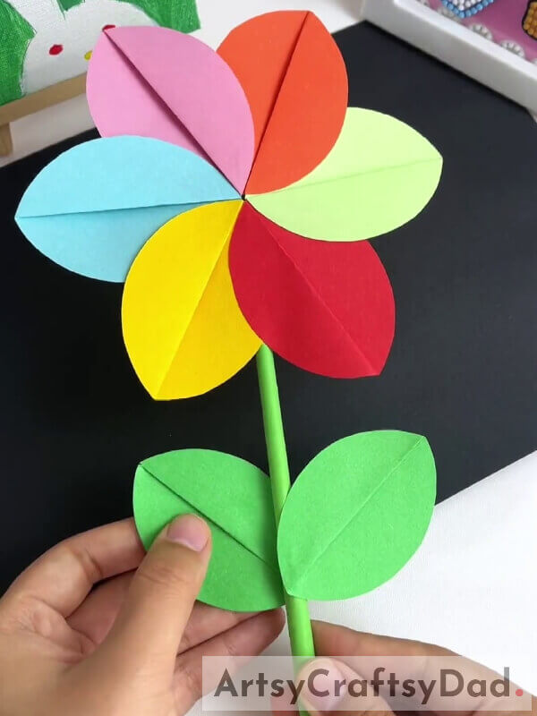 Sticking Leaves To The Stem - Help your children make a paper pinwheel flower with this tutorial