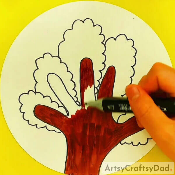 Take a brown sketch pen or marker and color the fingers - An Easy Guide for Kids to Learn How to Draw Trees with Outlined Hands 