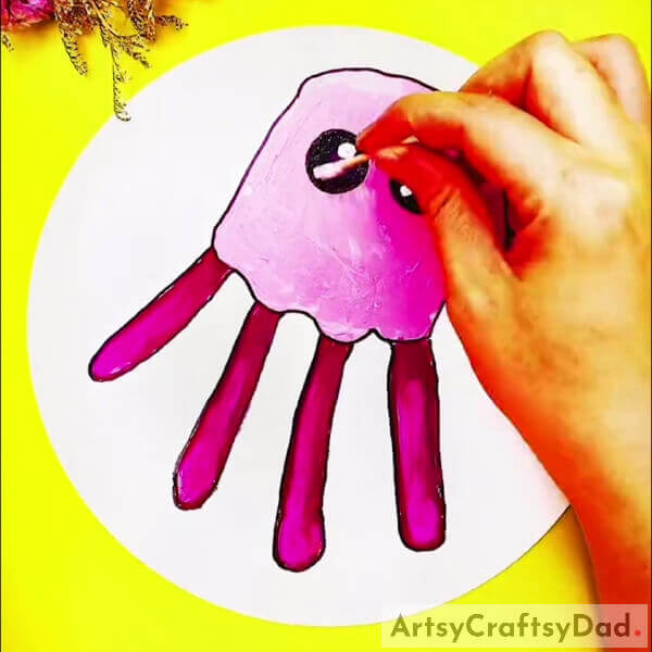 Taking Earbud to Make Eyes With a White Paint - Crafting a Handprint Jellyfish Picture Tutorial
