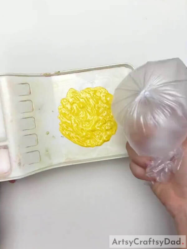 Taking Yellow Paint In Palette- A Guide for Novices on How to Make Polythene Art with Flowers 