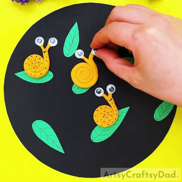 Adding Eyes To Your Snail-Fantastic Clay Snails On Leaves Craft For Kids