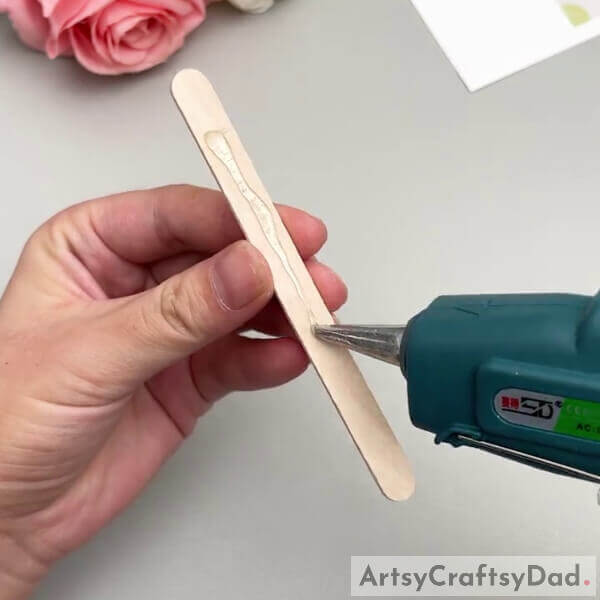 Applying Hot Glue- Step-by-step instructions for making an aeroplane out of popsicle sticks