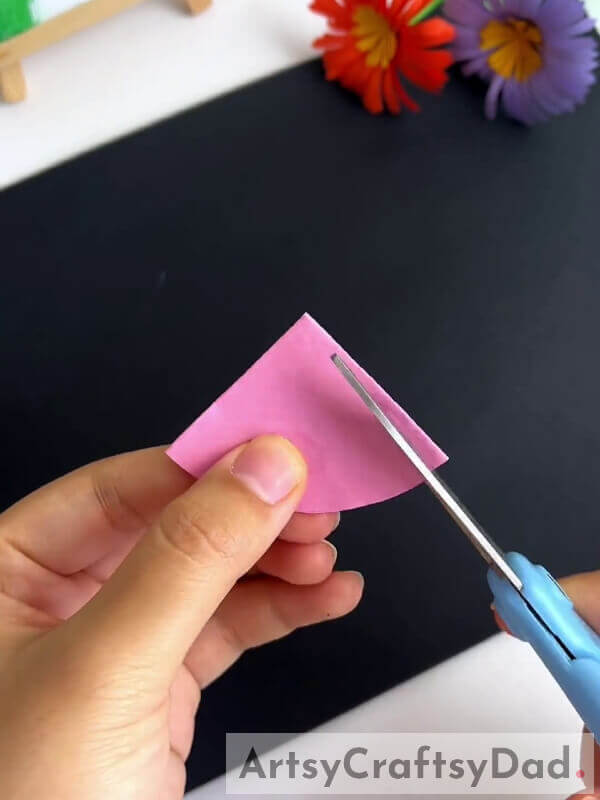 Cutting Pink Craft Paper To Make Petals- Step-by-step Guide to Crafting Fake Blooms with Scissors