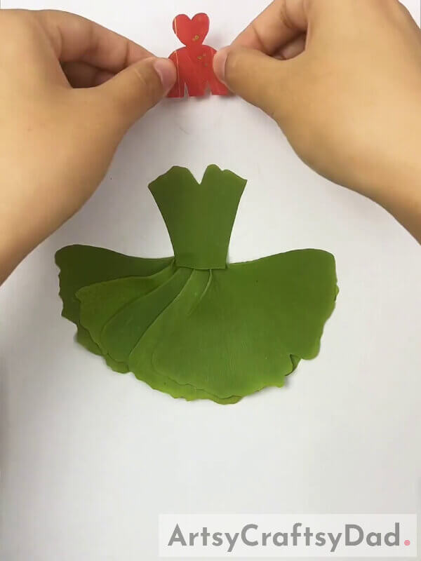 Cutting Red Color Leaf To Create Girl's Hair- Instructions For Crafting A Charming Leaf Dress For Youngsters