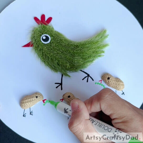 Draw Some Worms- A lesson in constructing a hen with chicks out of artificial grass and peanut shells