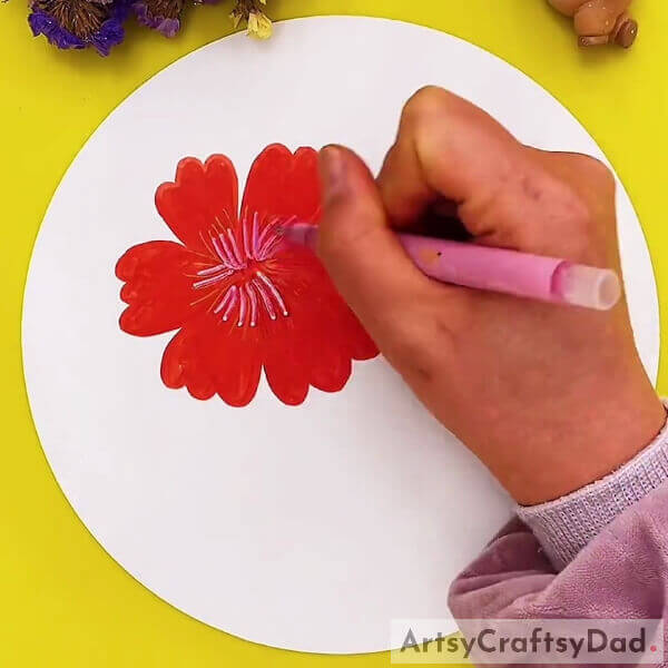 Drawing Pollen For Our Poppy Flower Using Pink Glitter Pen- An illustrated tutorial for kids to create a red poppy flower